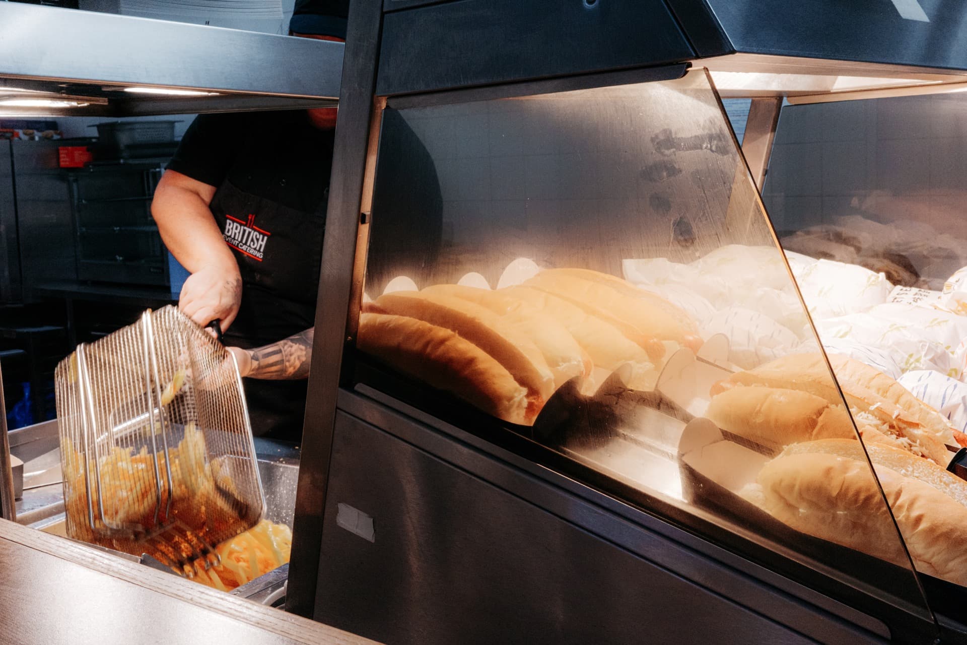 The stadium kitchen preparing hot dogs and chips
